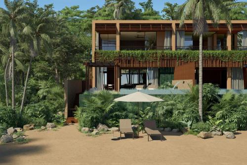 a building with two chairs and an umbrella at Siari, a Ritz-Carlton Reserve 