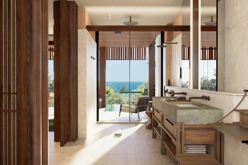 a bathroom with a sink and a view of the ocean at Siari, a Ritz-Carlton Reserve 