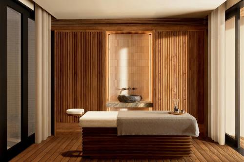 a bathroom with a large bed and a bath tub at Siari, a Ritz-Carlton Reserve 