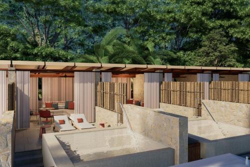 a building with a pool in the middle of a patio at Siari, a Ritz-Carlton Reserve 
