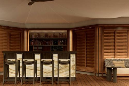 a room with wooden cabinets and a table and chairs at Siari, a Ritz-Carlton Reserve 