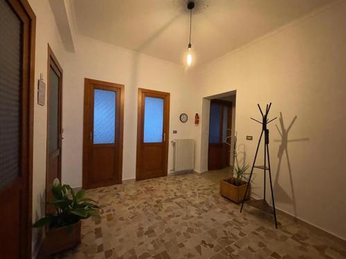 a room with a hallway with doors and a tripod at Mimosa House Torino in Turin