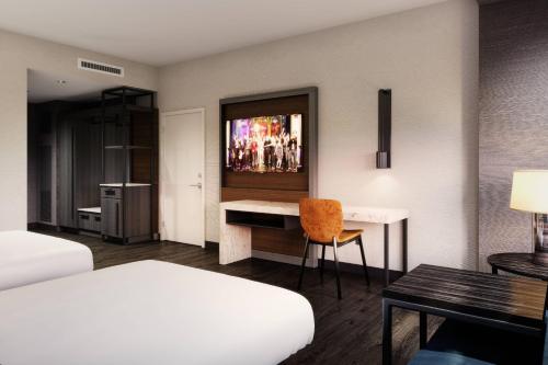 a hotel room with a bed and a desk at Marriott Owings Mills Metro Centre in Owings Mills