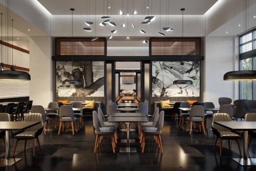 a restaurant with tables and chairs in a room at Marriott Owings Mills Metro Centre in Owings Mills