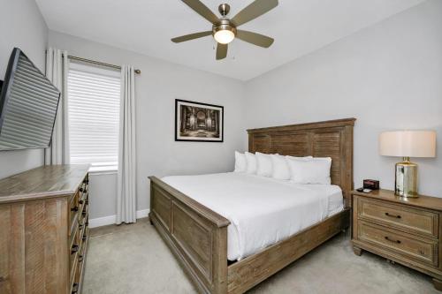 a bedroom with a bed and a ceiling fan at Grand Home Near Disney With Private Pool, Air Hockey Table And Waterpark & Resort Access At Encore Resorts Reunion - 401Sf in Kissimmee