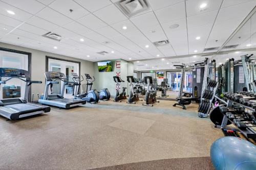 a gym with treadmills and machines in a room at Grand Home Near Disney With Private Pool, Air Hockey Table And Waterpark & Resort Access At Encore Resorts Reunion - 401Sf in Kissimmee