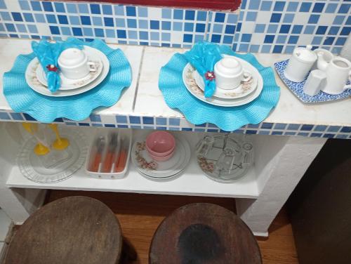 a shelf with plates and cups and saucers on it at Casinhas de Pipa in Pipa