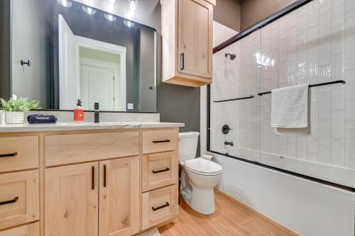 a bathroom with a sink and a toilet and a tub at Rural Home with Hot Tub Less Than 7 Mi to Winery and Golfing in Muenster