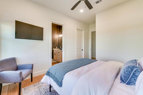 a bedroom with a bed and a chair and a television at Rural Home with Hot Tub Less Than 7 Mi to Winery and Golfing in Muenster