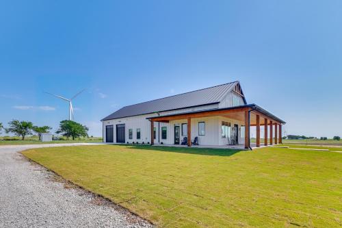 a large white building with a grass field in front at Rural Home with Hot Tub Less Than 7 Mi to Winery and Golfing in Muenster