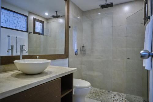 a bathroom with a sink and a toilet and a shower at Apartahotel Poblado-Aguacatala in Envigado