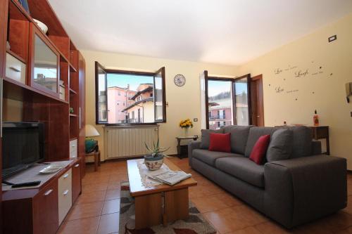 a living room with a couch and a tv at Sunrise in Baveno - Happy Rentals in Baveno