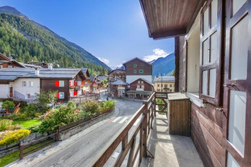 a town in the mountains with a view of a street at Monterosa Cozy Apartment 200m From Ski - Happy Rentals in Macugnaga