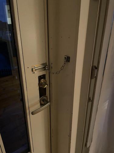a door with a chain attached to it with a lock at Charming apartment in Tromsø