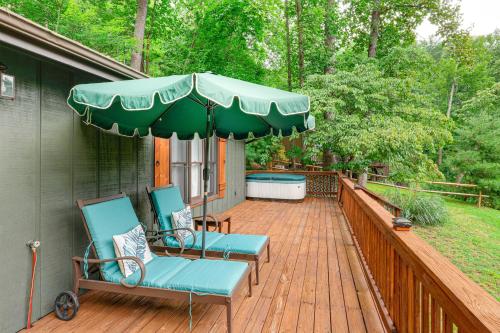 a deck with two chairs and an umbrella at Deck and Game Room! Lakefront Blue Ridge Mtn Gem in Powderhorn Mountain