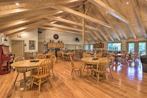 a dining room with wooden tables and chairs at Deck and Game Room! Lakefront Blue Ridge Mtn Gem in Powderhorn Mountain