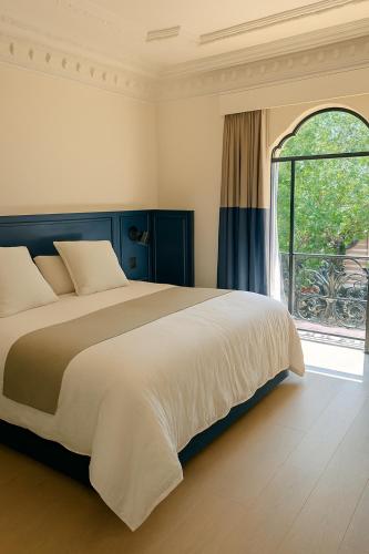 a bedroom with a large bed and a window at Casa Amari in Mexico City