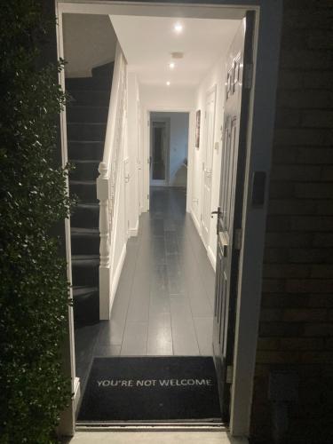 a hallway with a sign that says youre not welcome at Entire 3 bedroom deluxe house in Cleckheaton