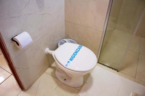 a bathroom with a toilet with a football on it at Hotel Rosim in Pirassununga