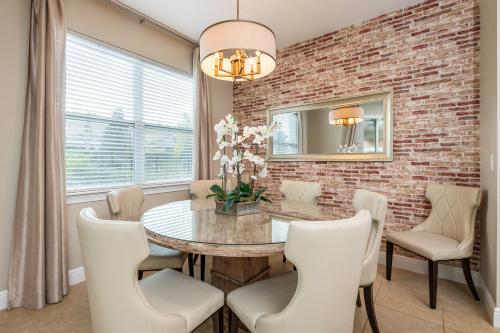 a dining room with a brick wall and a table and chairs at Gorgeous Home With Media, Disney Themed Kids Room Near Disney With Waterpark & Resort Access At Encore Resort - 771La in Kissimmee