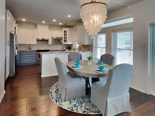 a kitchen with a dining room table and chairs at West Bay Getaway in Galveston