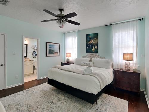 a bedroom with a bed and a ceiling fan at West Bay Getaway in Galveston