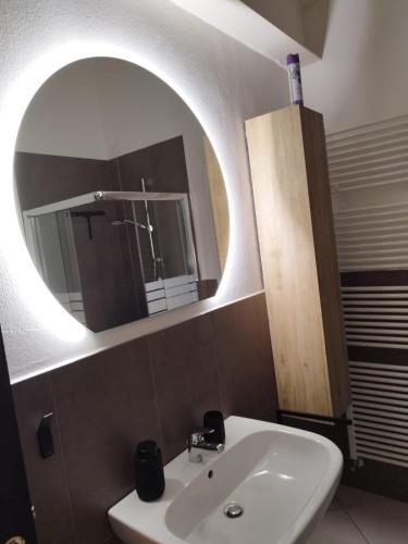a bathroom with a white sink and a mirror at Le Torri Lodge, exclusive comfort in the center in Forlì