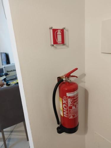 a fire extinguisher is hanging on a wall at Le Torri Lodge, exclusive comfort in the center in Forlì