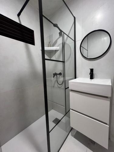 a bathroom with a shower and a sink and a mirror at Casa Paraíso in Adeje