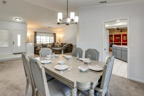 a dining room and living room with a table and chairs at Pool, Spa and Mountain Views Apple Valley Retreat! in Apple Valley