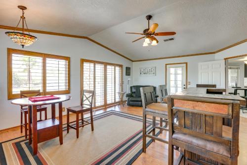 a kitchen and living room with a ceiling fan at Pool, Spa and Mountain Views Apple Valley Retreat! in Apple Valley