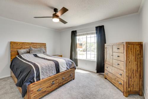 a bedroom with a bed and a dresser and a window at Pool, Spa and Mountain Views Apple Valley Retreat! in Apple Valley