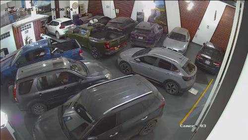 a group of cars parked in a garage at Hotel El Castor in Huaraz