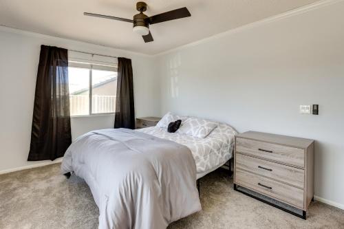 a bedroom with a bed and a ceiling fan at Pool, Spa and Mountain Views Apple Valley Retreat! in Apple Valley