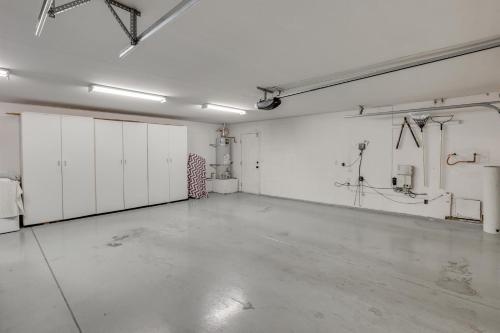a large room with white walls and white cabinets at Pool, Spa and Mountain Views Apple Valley Retreat! in Apple Valley