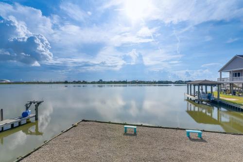 a large body of water with a dock and benches at Private Bayfront Access 10 Mi to Galveston Beaches in Hitchcock