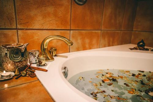 a bathroom with a sink with leaves on it at Elowen Suites Downtown in Drumheller