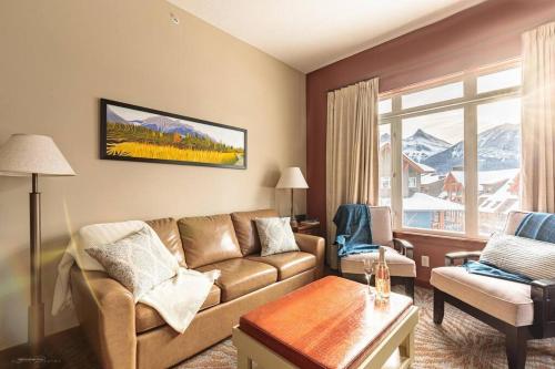 a living room with a couch and a table at Sun Drenched Escape in Canmore