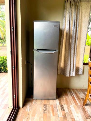 a refrigerator in the corner of a room at Cabañas El Manantial in Esquipulas
