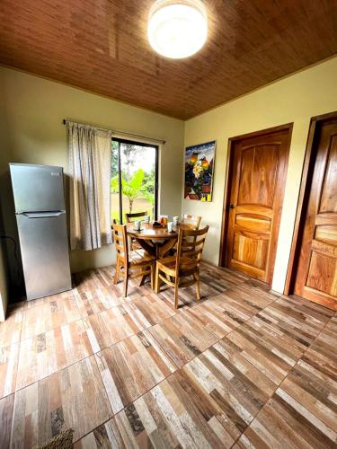 a dining room with a table and a refrigerator at Cabañas El Manantial in Esquipulas