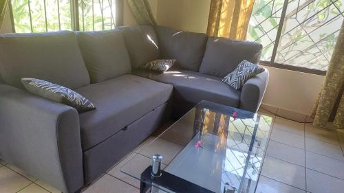 a living room with a couch and a coffee table at Casa Plumeria-Aloha Surf Nosara in Nosara