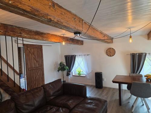 a living room with a couch and a table at Friend's homestead 