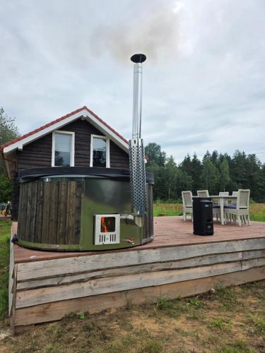 a house with a grill on a wooden deck at Friend's homestead 