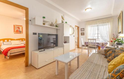 a living room with a couch and a television at 2 Bedroom Amazing Apartment In Torrevieja in Torrevieja