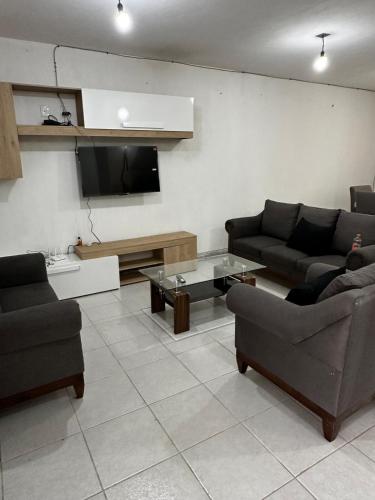 a living room with two couches and a tv at Casa muy cómoda de 2 pisos en zona muy tranquila in Media Fanega