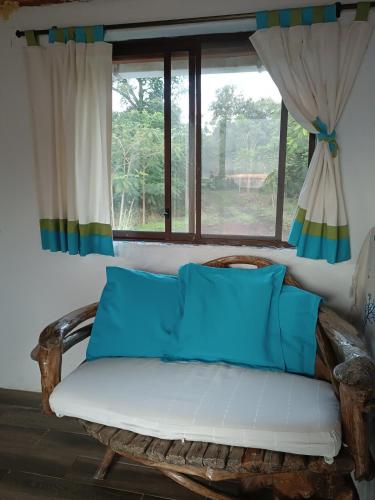 a couch in a room with a window at El Mango - rural house with fast internet in San Cristobal