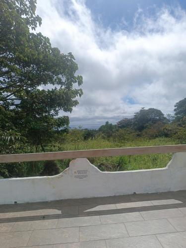 a park bench with a view of a forest at El Mango - rural house with fast internet in San Cristobal