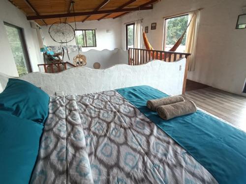 a bedroom with a large bed with two pillows on it at El Mango - rural house with fast internet in San Cristobal