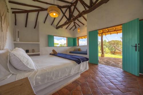 a bedroom with a bed with green sliding doors at Buratá Haus Hotel Boutique in Barichara