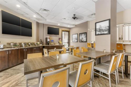 a dining room with wooden tables and chairs at Best Western InnSuites Tucson Foothills Hotel & Suites in Tucson